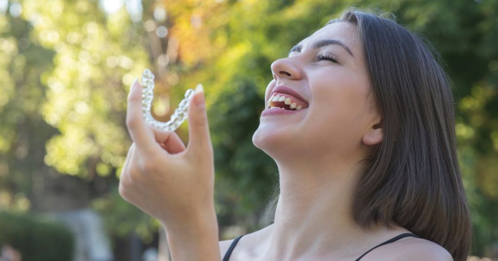 Woman taking out her Invisalign to eat